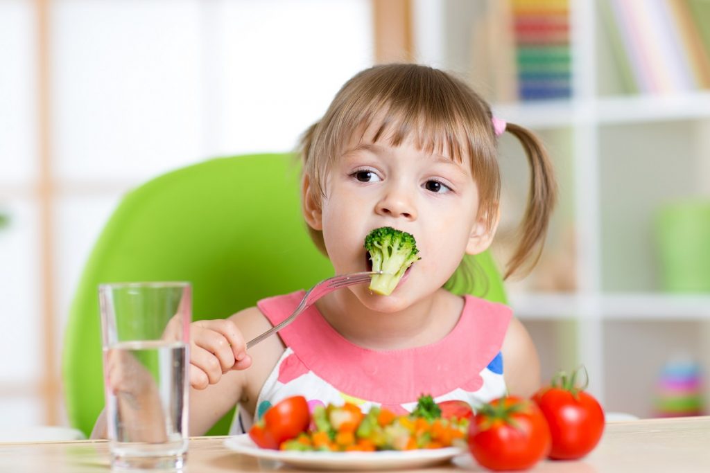 Little girl eating her vegetables
