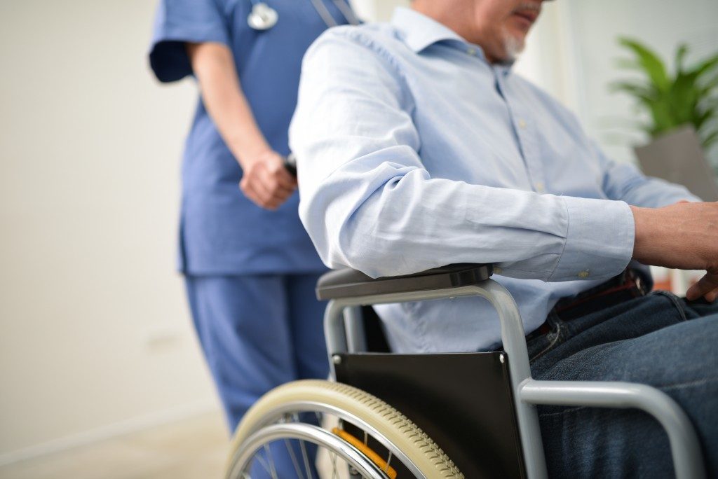 Nurse pushing the patient's wheelchair
