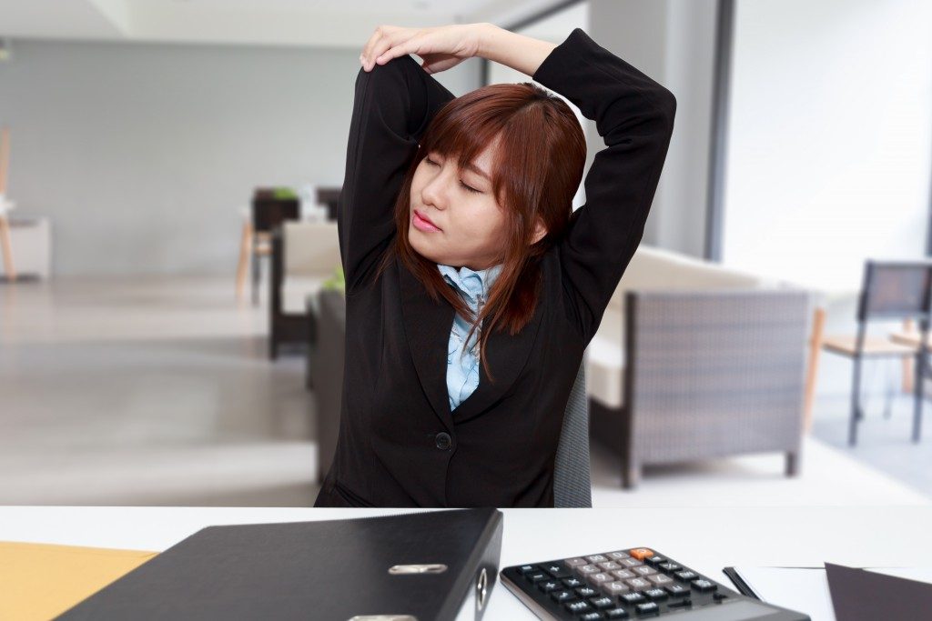 employee doing stretches in her desk