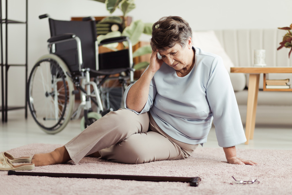 elderly woman sitting on a carpet
