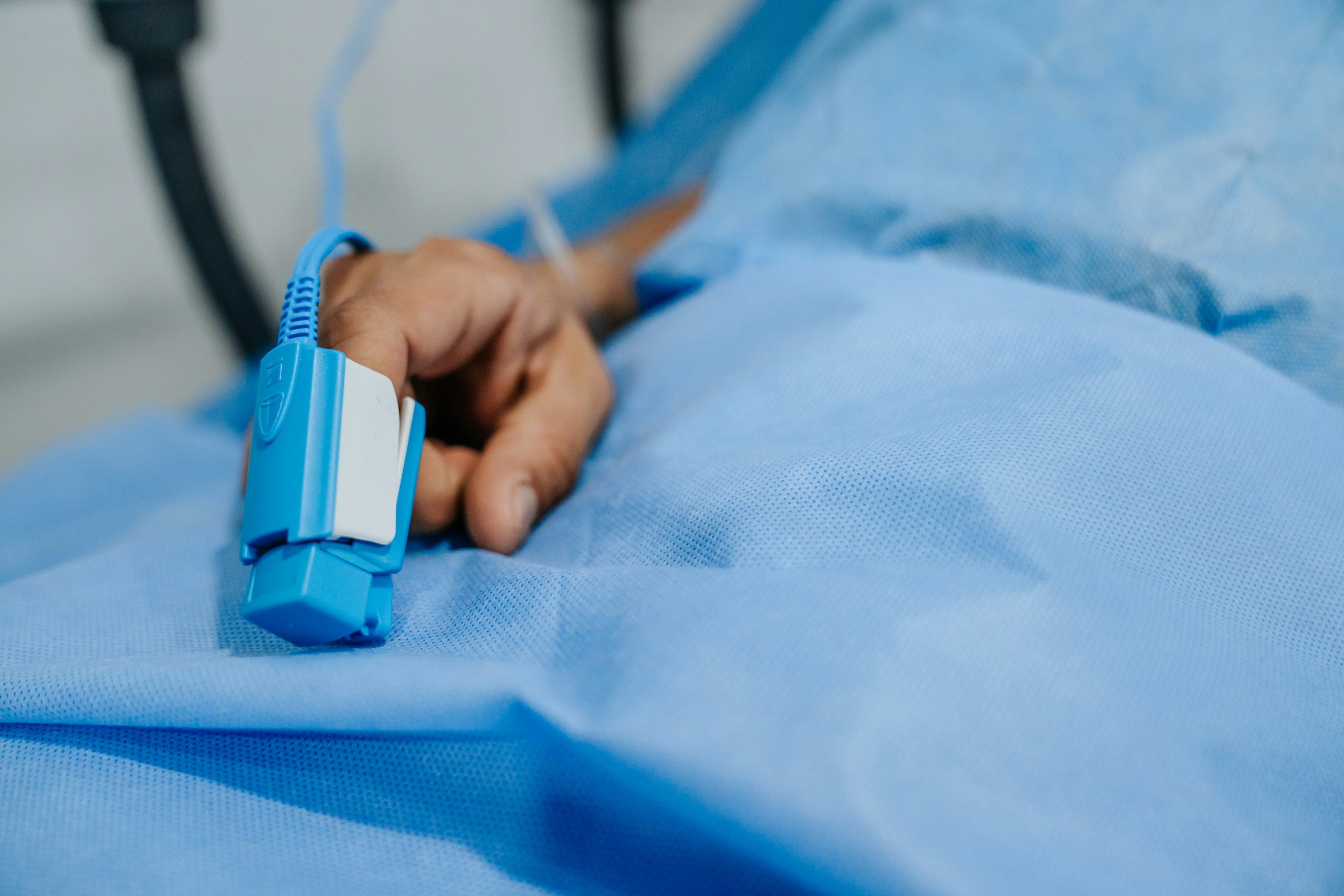 close-up of a patient's finger with a pulse oximeter