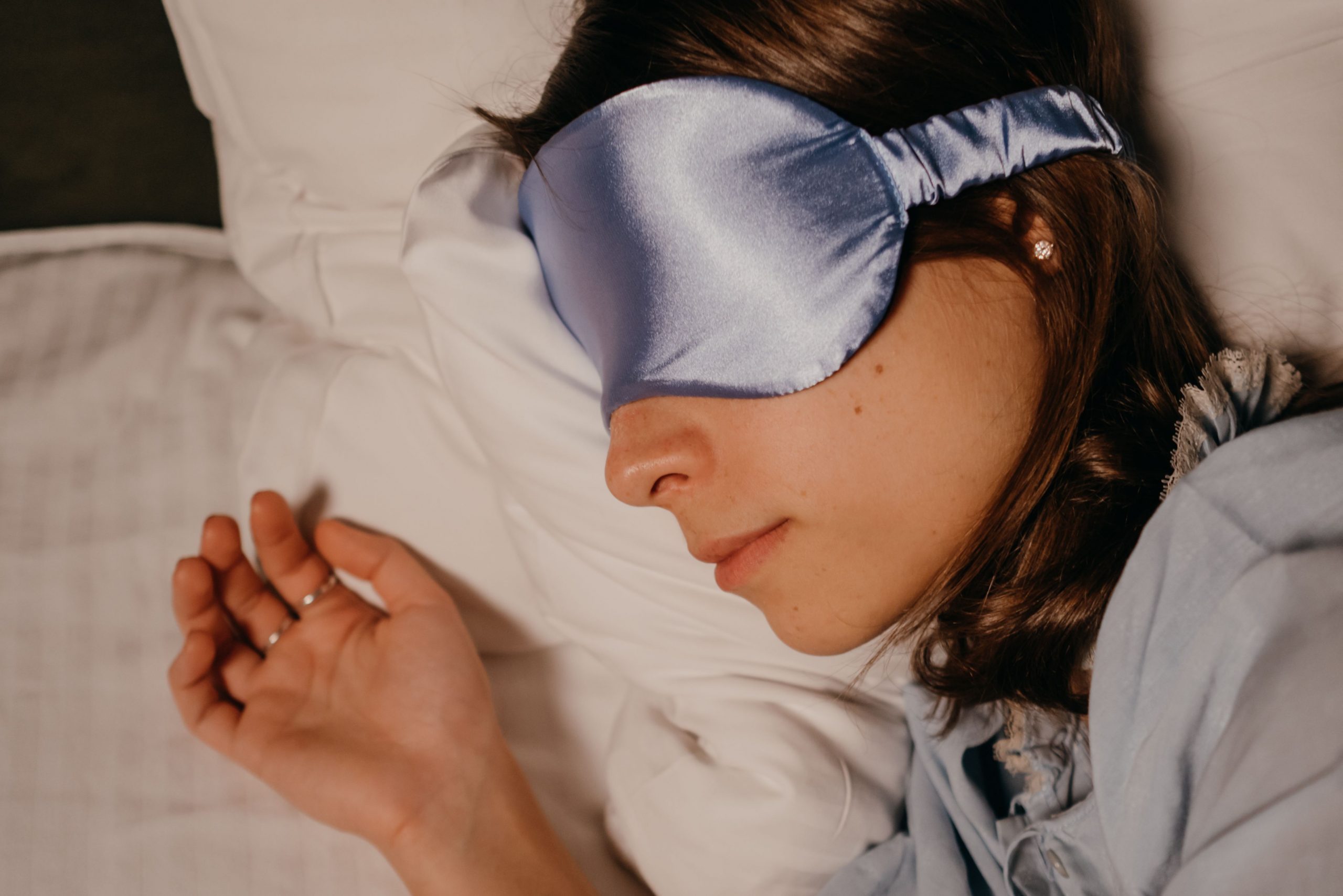 woman wearing an eye mask, sleeping peacefully